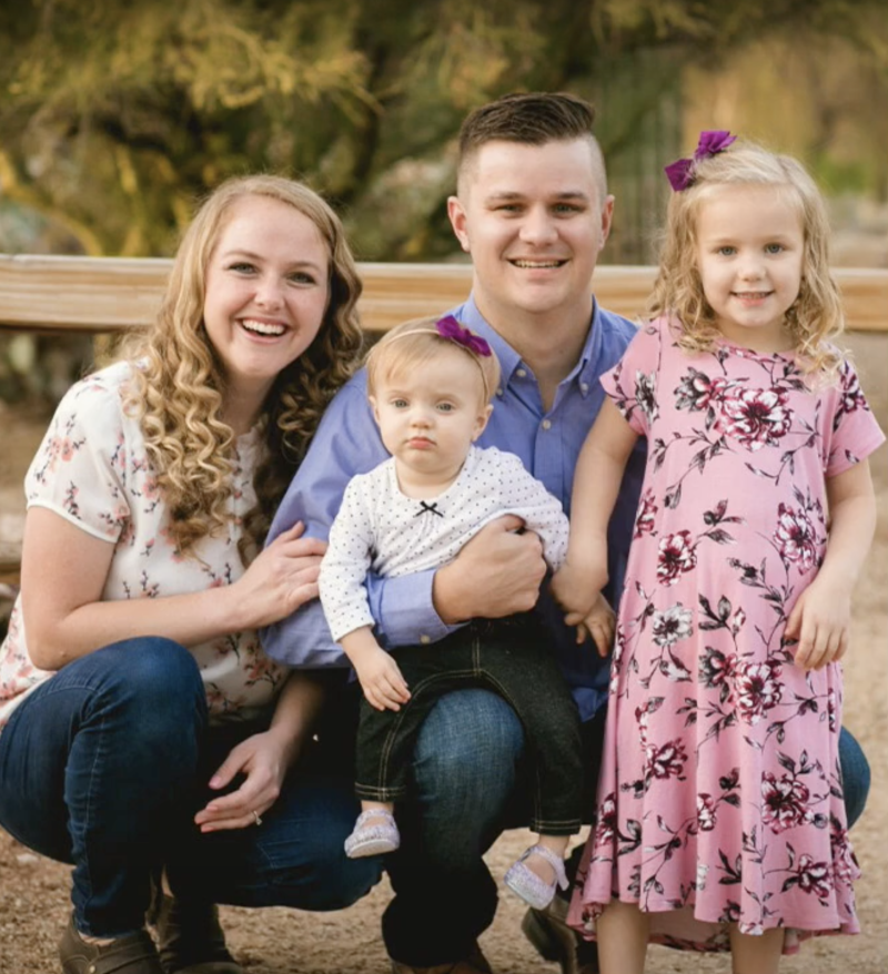 Miranda Newman smiles in a photograph with her husband and two children.