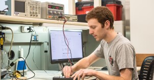 An Electrical Engineering student works with an electrical device.