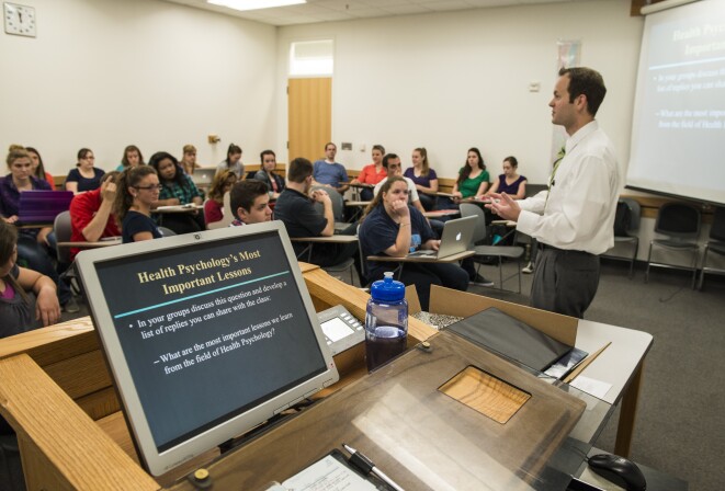 A health psychology professor teaches students