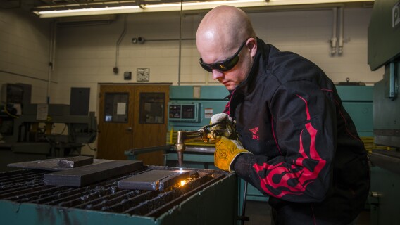 Student works on a welding project in the Austin building.