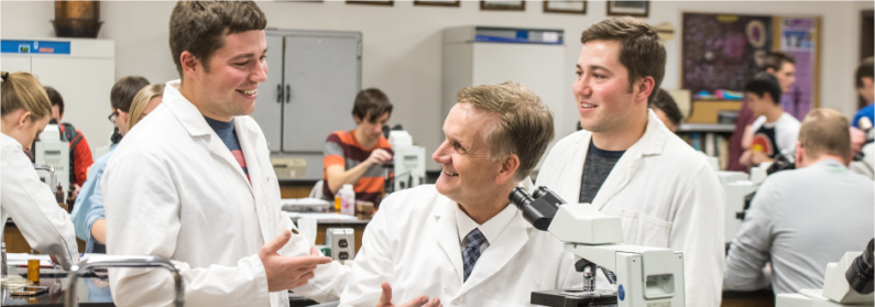 Students chat with a lab professor
