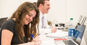 Business Management students take notes and complete work.