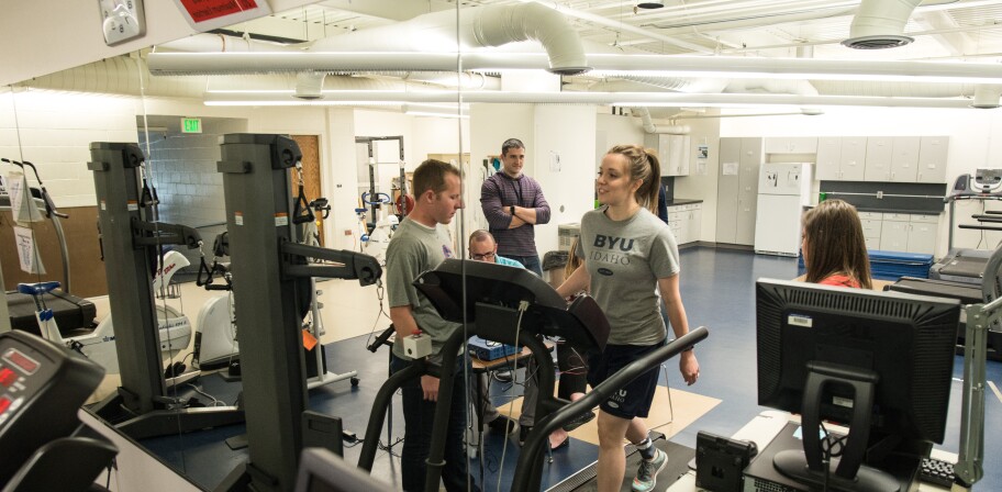 Other students watch as an Exercise Science student walks on a treadmill.