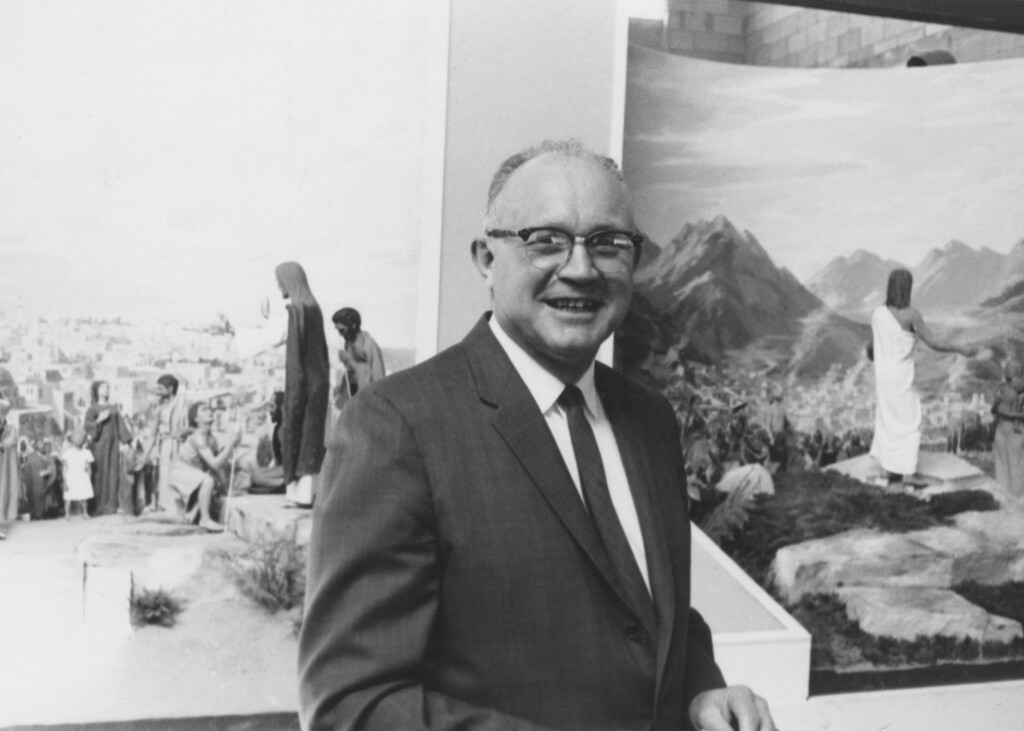 Elder Brockbank Smiling in front of Jesus Christ Diorama