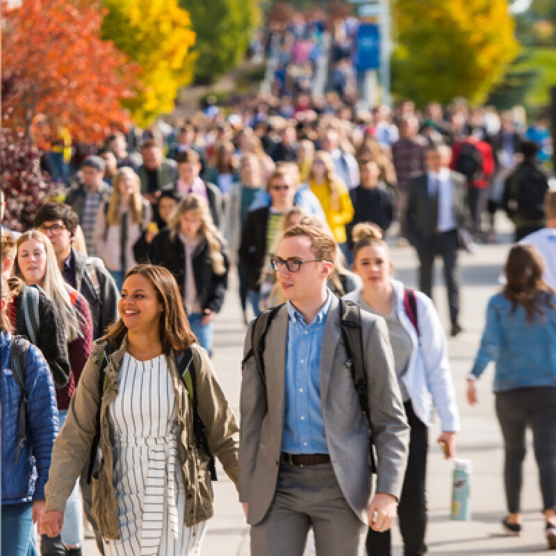 A crowd of students on campus during fall semester