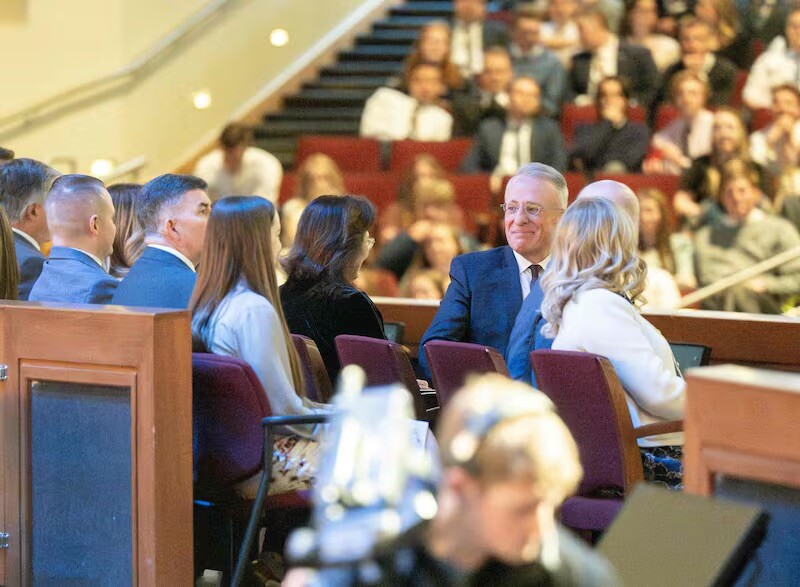 Elder Ulisses Soares of the Quorum of the Twelve Apostles listens as the choir sings in Portuguese, his native language, during a devotional held in the BYU–Center in Rexburg, Idaho, on April 27, 2025.