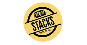 Stacks Logo "STACKS; SANDWICH SHOP" written in black, slanted to the left with yellow background; cartoon drawing of a sandwich also in black, on top of "STACKS"