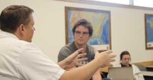 Matt Miles consults with a student one on one