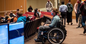 A BYU-Idaho student in a wheelchair waits patiently for a devotional to start.