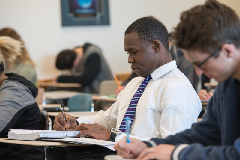 A BYU-Idaho student takes notes during a Math 101 class.