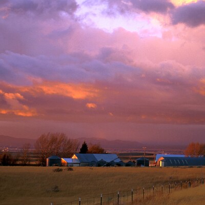 A vibrant sunset overcasts the clouds above a local farm near Rexburg.