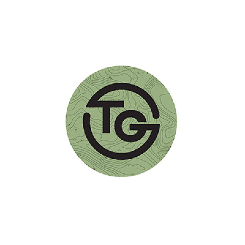 Teton Grill Logo "TG" written in black with gray/green swirl background.