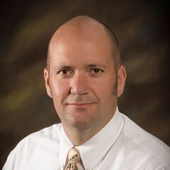 A professional photo of Faculty Hyrum Benson.