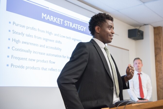 Students present their final group projects in a Business Essentials Class.