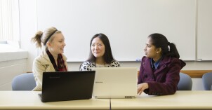 Software Engineering students talk with each other.