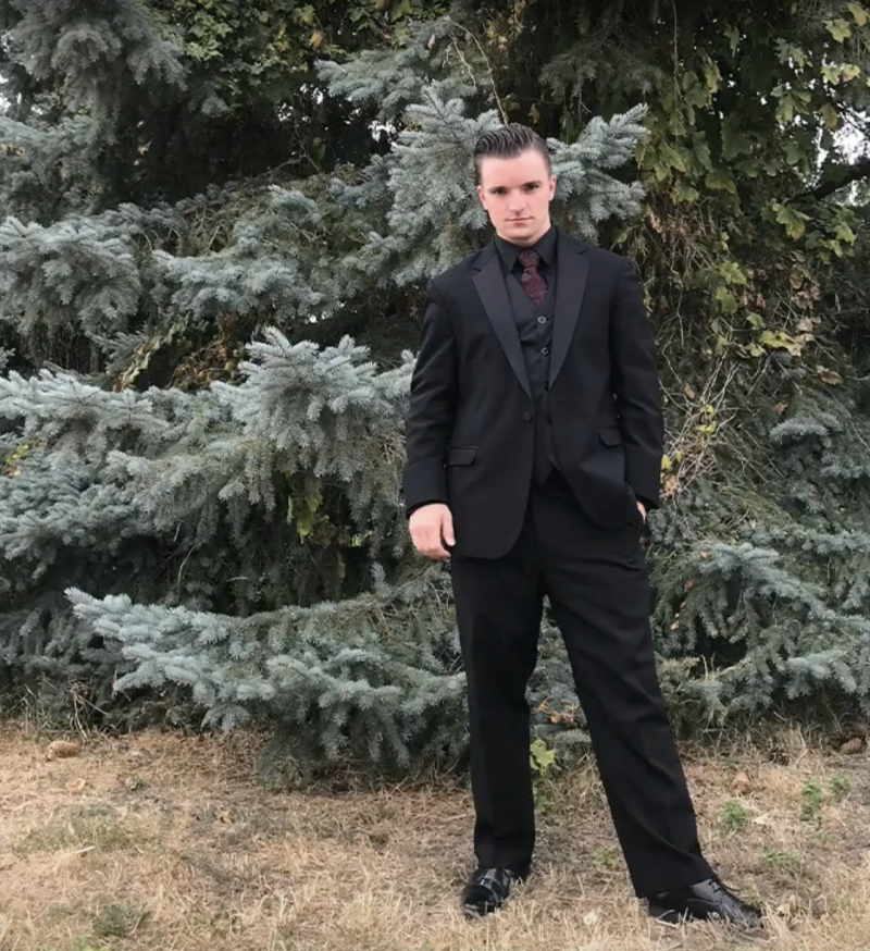 Photo of Alexander Purser in front of some pine trees