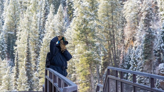 A student takes photos of Mesa Falls in the winter.
