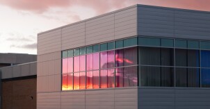 A sunset reflects glass on the Manwaring Center at BYU-Idaho.
