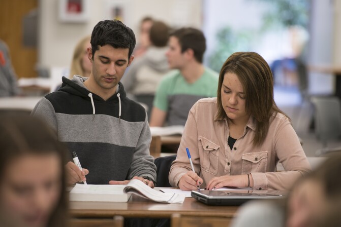 A tutor helps a student study for class