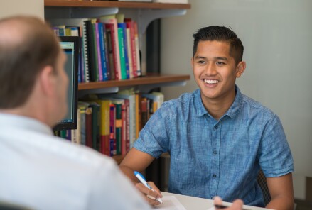 Cody Wong talking to a faculty