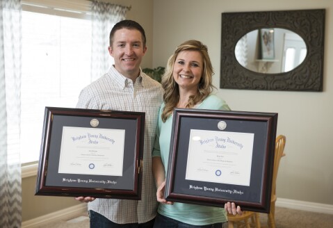 Two BYU-Pathway Worldwide online students display their online degrees from BYU-Idaho.