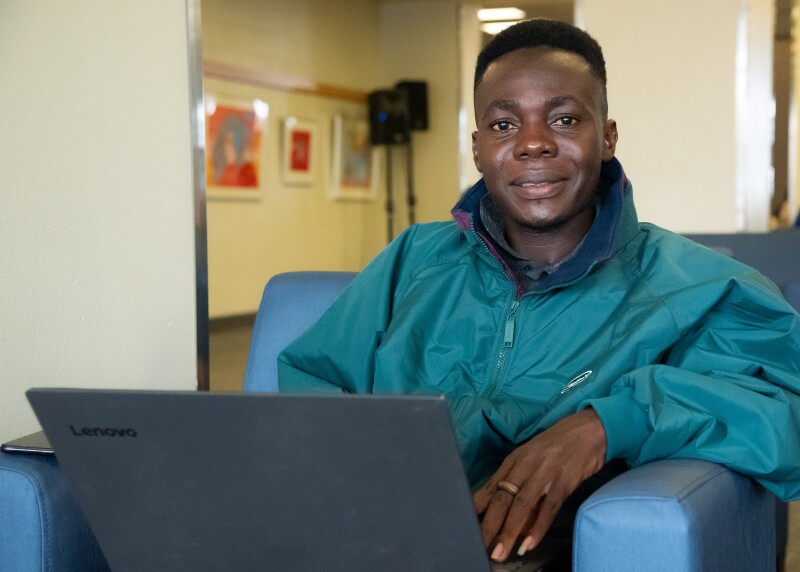A student studying inside the MC poses for a photo.