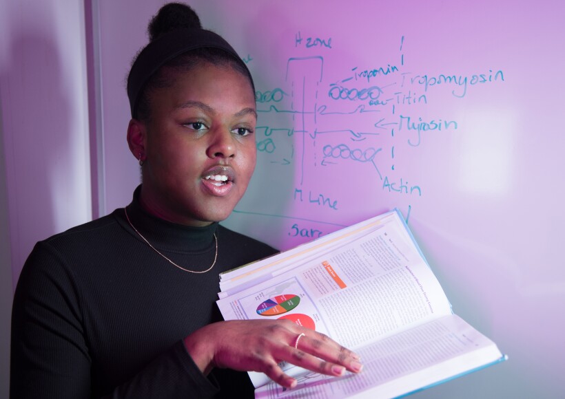Biology student reads from a book