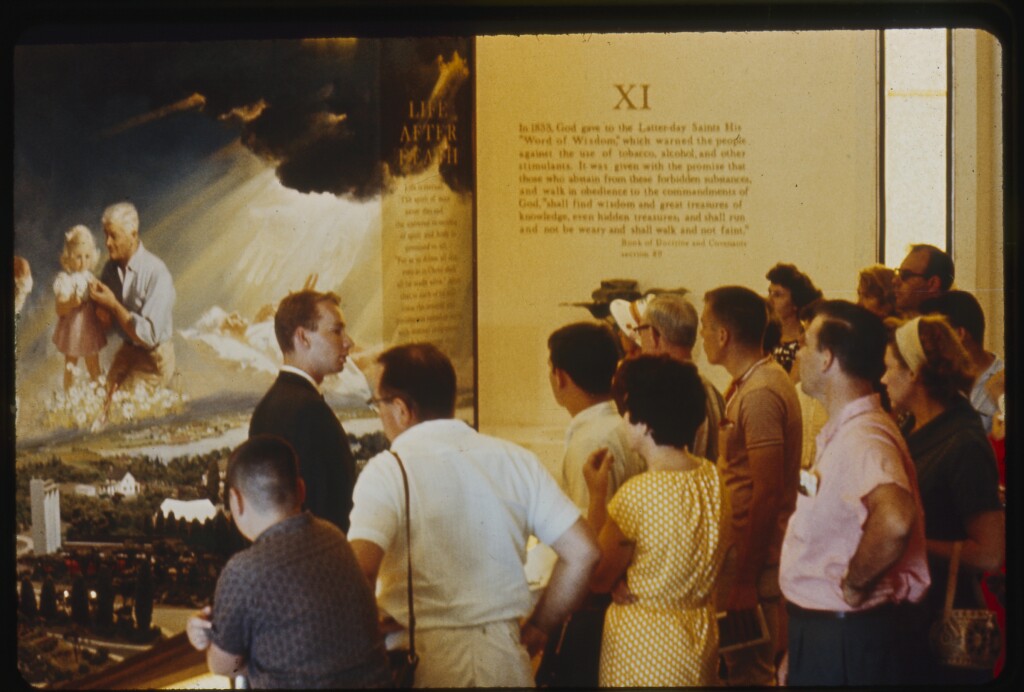 A group of people looking at exhibits at Mormon Pavilion NY World's fair