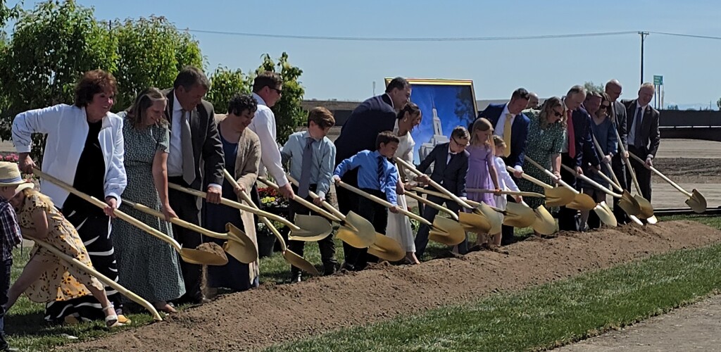 A group of people turn dirt