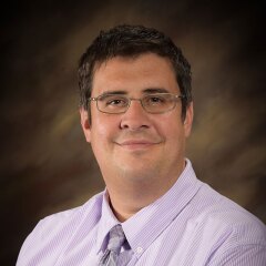 A professional photo of Faculty Tim Howe.