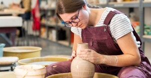 Ceramics student Whitney Carr throwing on the wheel.