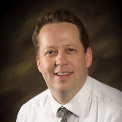 A professional photo of Faculty Ryan Muldowney.