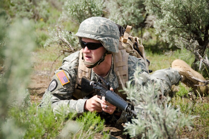 ROTC student doing an army crawl on the ground West of R Mountain.