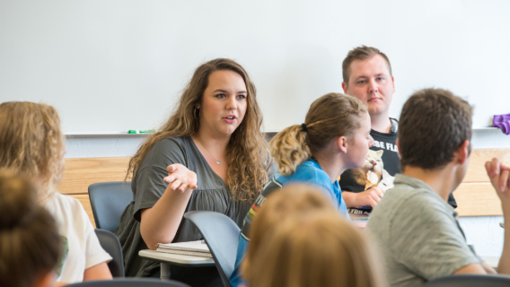 A marriage and family studies student discusses with the rest of class