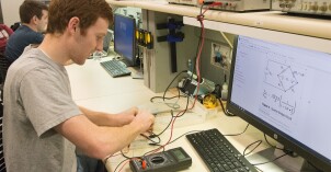 A BYU-Idaho student tests the electrical current on a device while fulfilling a computer science and electrical engineering internship.