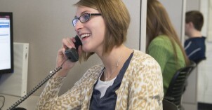 An Online Support Center worker talking on the phone