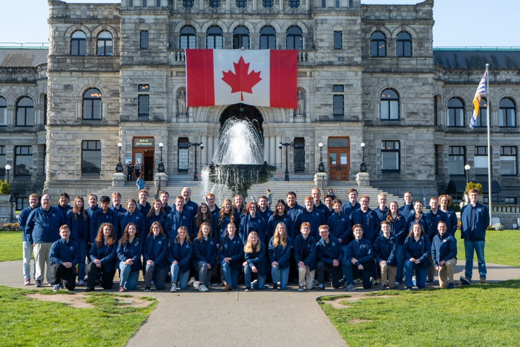 Band poses for a photo in front of the legislative assembly of British Columbia