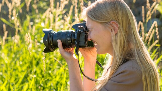 A photography student takes pictures in nature.