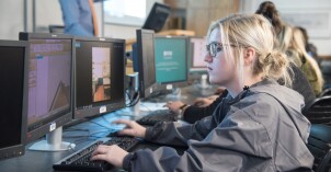 A Design and Construction Management student works on a computer.
