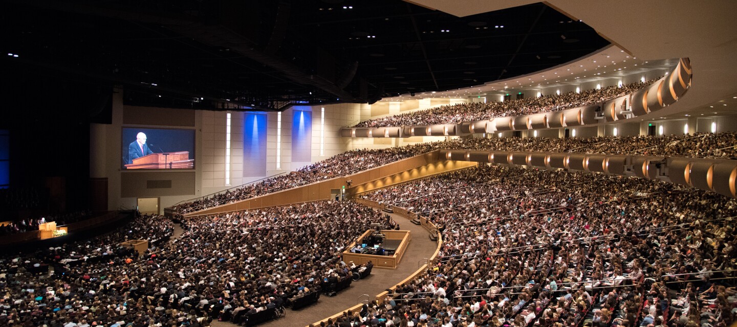 view of a full auditorium with a main speaker at the front