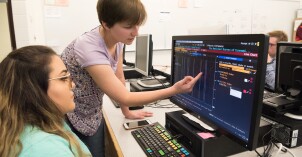 Students work on an assignment with the help of a Bloomberg computer.