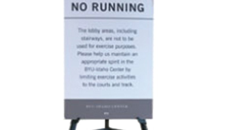 An image of a foam printed poster on a pedestal that reads "No Running."