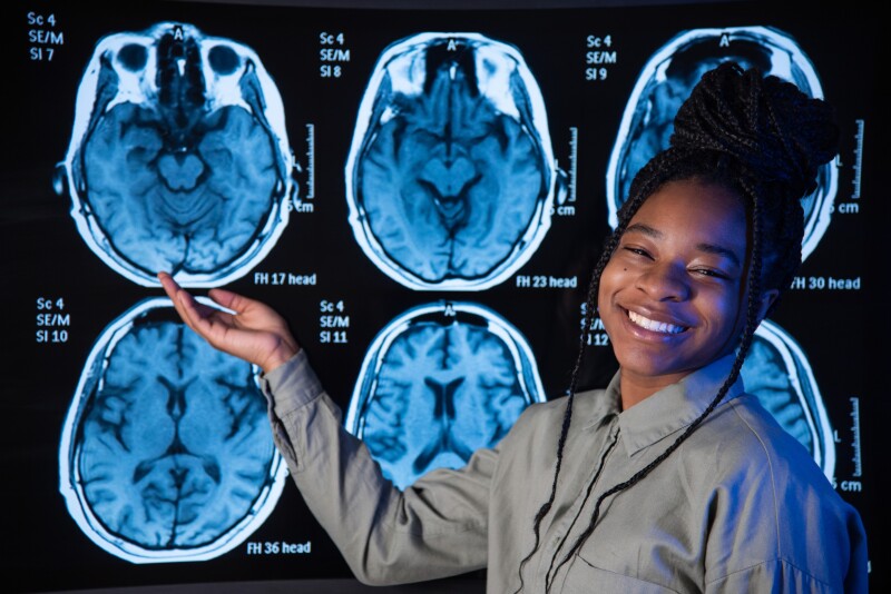 Psychology Student pointing at a scan of a brain