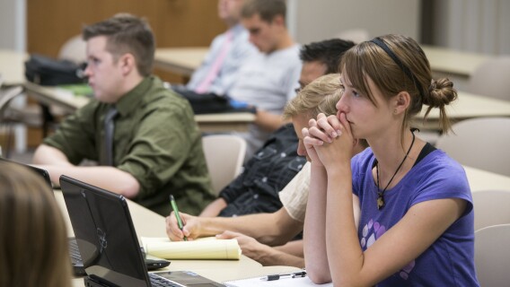 A female student listens intently during a public policy history class