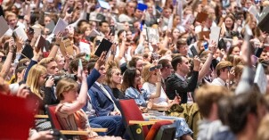 Students traditionally raise their scriptures, notebooks, and electronic devices at devotional to show their readiness to learn.