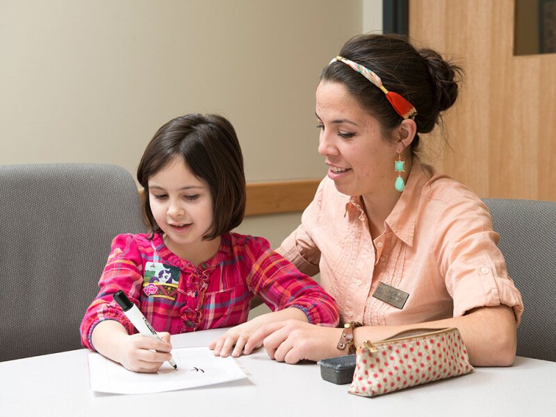 Student teacher tutoring a child