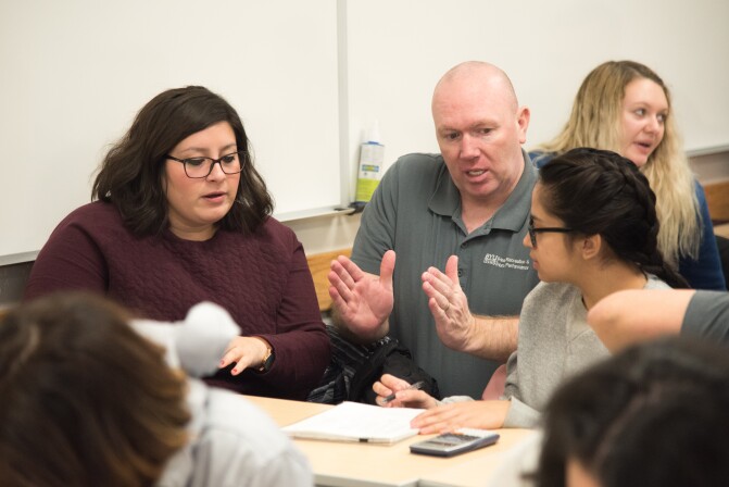 Brother Tyler Watson explains Math Concepts to the students in his Epidemiology Class.