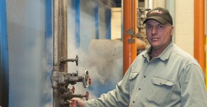 A BYU-Idaho employee turns a knob for a boiler pipe on the BYU-Idaho campus.