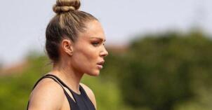 Chari Hawkins stands in profile with her hands on her hips