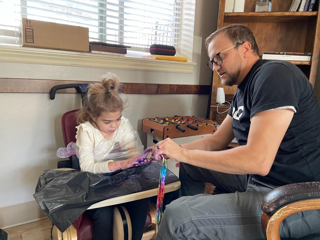 Avery Brizzee with her speech therapist, Matt Foster.